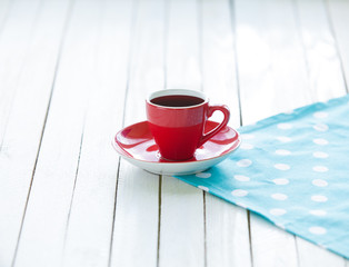 Cup of coffee or tea on polka dot napkin