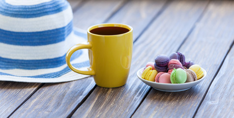 Cup of coffee and macarons with hat