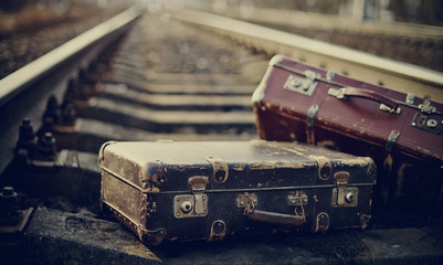 Old suitcases on railroad tracks