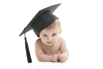 Portrait of a sitting baby with a graduation cap