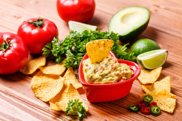 Guacamole with avocado, lime, tomato, and cilantro