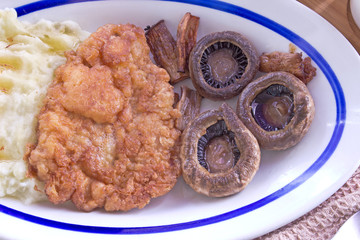 Wiener Schnitzel - breaded meat with potato and mushrooms