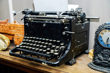 Old vintage typewriter with blank paper sheet