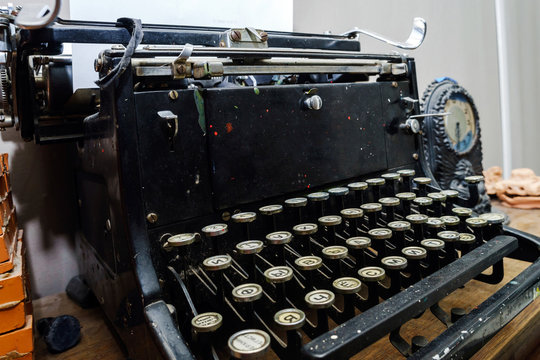Old vintage typewriter with blank paper sheet