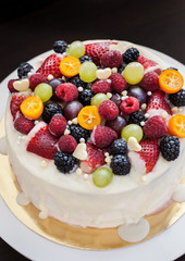 White chocolate cake decorated with fresh berries and fruits