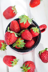 Fresh strawberries  in a tin mug