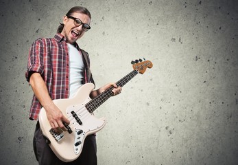 Art. Rock musician is playing electrical guitar.