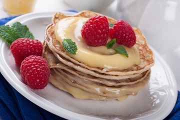 Delicious pancakes with lime curd and raspberries.