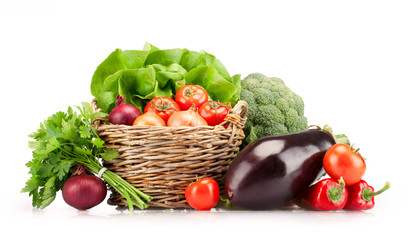 Full basket of ripe vegetables on white background