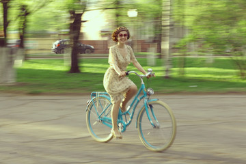 cheerful girl on a bicycle movement