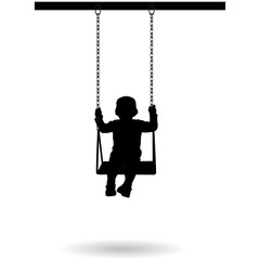 Boy swinging on a swing in the park