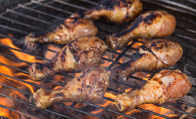 Delicious chicken legs on garden grill