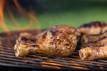Delicious chicken legs on garden grill
