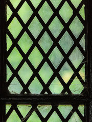 green stained glass window with regular block pattern