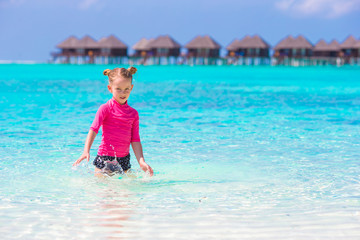 Adorable little girl at beach during summer vacation