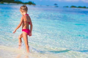 Fototapeta premium Adorable little girl at beach during summer vacation