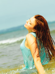 Fototapeta na wymiar Vacation. Girl in water having fun on the sea.