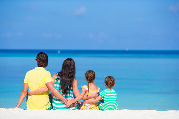 Obraz premium Happy beautiful family on white beach during summer vacation