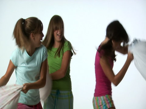 Tween girls pillow fighting