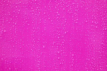 Water drop on pink background.