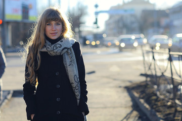 Spring portrait of a young girl in the sun in the evening