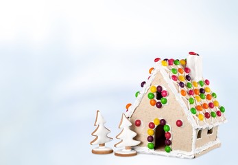 Gingerbread. Homemade gingerbread house on brown background