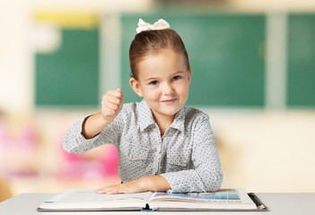 Aggressive. Schoolgirl sitting at the desk