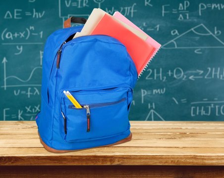Backpack. Studio shot of a school backpack with books, isolated