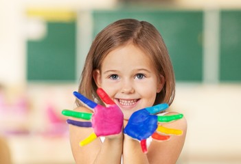 Art. Smiling child showing his colored hands