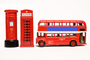 Postbox and red telephone box with red bus