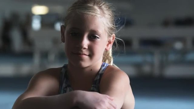 CU Portrait of g girl (10-11) sitting in gym, Orem, Utah, USA