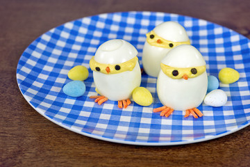 Easter deviled egg chicks with candy eggs.
