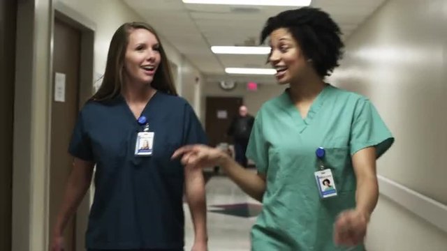 MS Two nurses walking through hospital corridor / Payson, Utah, USA