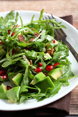 Light salad with arugula, avocado and pomegranate