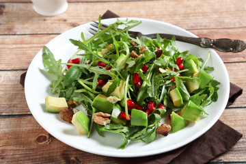 Salad with arugula, avocado and pomegranate