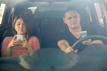 Man and woman texting and driving