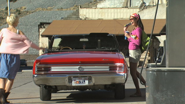 two women at a gas station