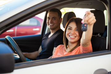 Hispanic couple with a new car