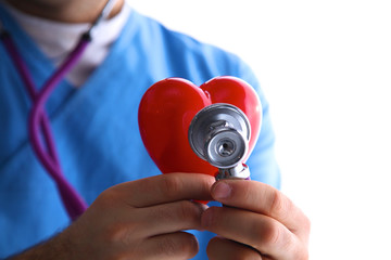 Doctor with stethoscope examining red heart, isolated on white