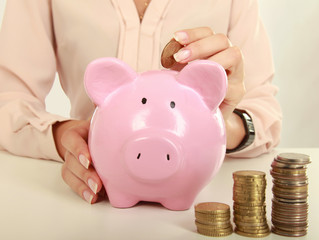 Young beautiful woman sitting with piggy bank ,money box