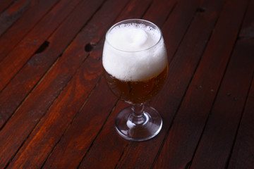 Glass of beer on wood