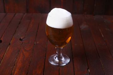 Glass of beer on wood
