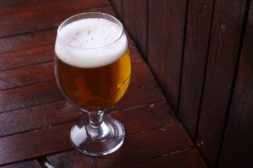 Glass of beer on wood