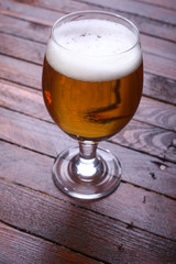 Glass of beer on wood