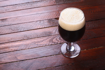 Dark beer on wood