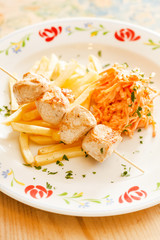 Chicken skewers with french fries