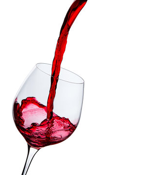 wine is poured into a glass on a white background