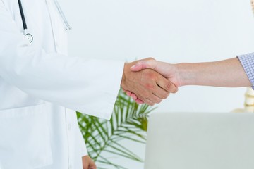Doctor shaking hand of his patient