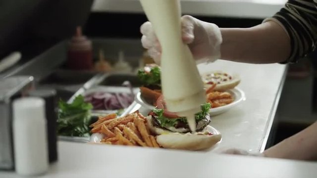MS TU TD Waitress preparing and serving sandwiches in diner / Provo, Utah, USA
