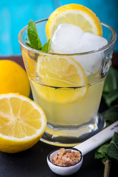 Refreshing lemonade with fresh citrus , mint and ice in glass